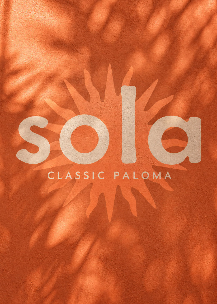 Sola branding on a warm orange wall with palm shadows